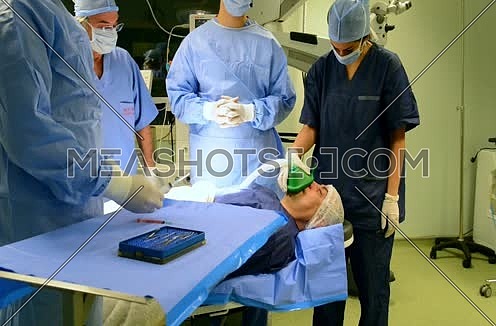 middle eastern doctors in operating room giving patient anesthesia mask
