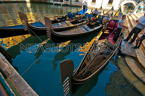 Venice Italy gondolas on canal at parking spot