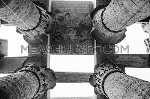 The top of a ceiling of Kom Ombo Pharaoh temple held on a huge columns decorated in a Papyrus shape at the top