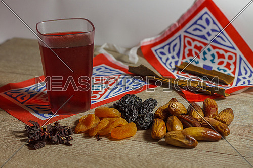Dates, Karkade Drink (hibiscus tea)  and Ramadan Decorations on a wooden table top