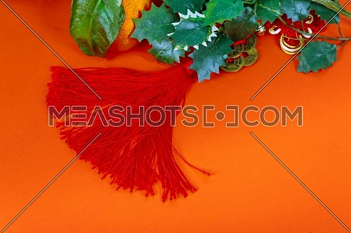 Chinese new year decorations, on red glitter decorations background and tangerines