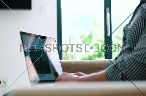  handsome man using laptop sitting on sofa