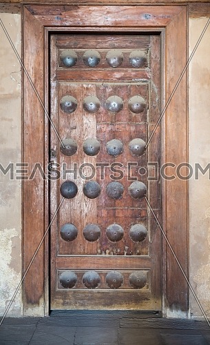 Grunge wooden aged door on grunge stone wall, Medieval Cairo, Egypt