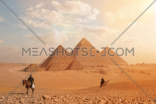 tourism police on camel and horse patrolling the area of giza pyramids in Egypt