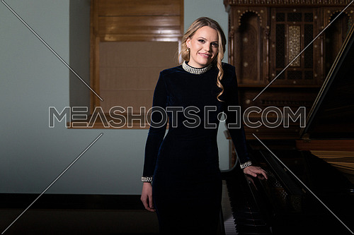 Portrait of a Piano Playing Pianist Concert - Classical Music Musician Player With Grand Piano