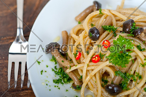 Italian pasta and mushroom sauce over rustic old wood