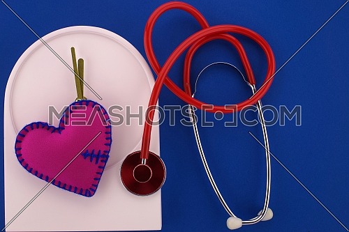 Medical concept with stethoscope and red heart on the clock, free space for text