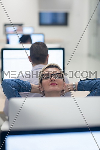 startup business, woman  working on dektop  computer at creative modern office relaxing and have fun