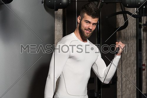 Young Handsome Man Exercise Biceps On Machine