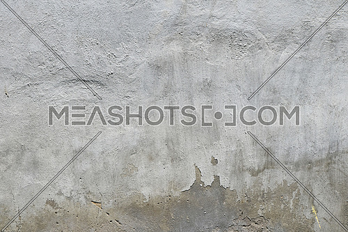 Old white and grey painted lime plaster concrete wall with weatherstains, runs and defects