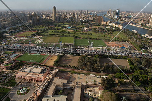 aerial view of modern Greater Cairo city downtown with Nile and pyramids in the horizon on a beautiful sunny day with blue sky and clouds capital of Egypt
