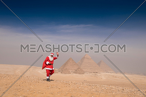 santa claus in egyptian pyramids desert