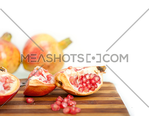 fresh pomegranate fruit on  wood over white background