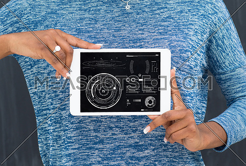Young Happy African American Woman Using Digital Tablet  Isolated on a gray background