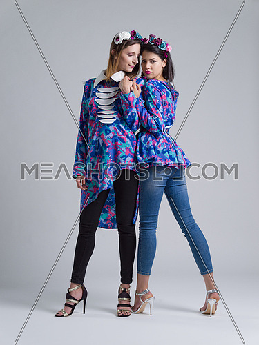 two Fashion Model girls isolated over white background. Beauty stylish women posing in fashionable clothes  Casual style with beauty accessories. High fashion urban style