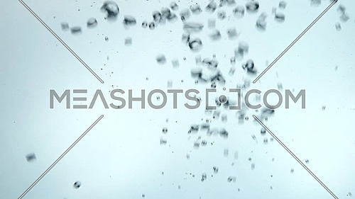 Pouring pure clear cold water in transparent glass jar with small bubbles of stream, close up, low angle side view, slow motion