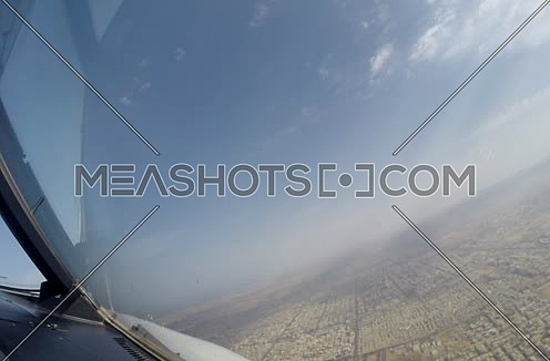 inside cockpit shot  flying over a city  at day