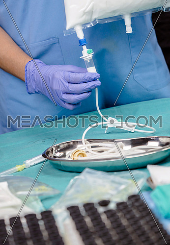 Nurse preparing medication for parenteral nutrition in a hospital, conceptual image