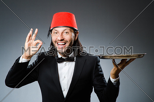 Waiter wearing traditional turkish hat 