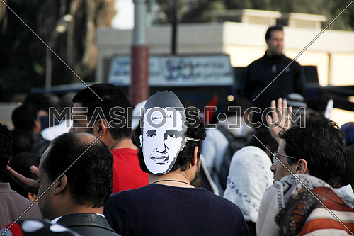 A man from his back wearing khaled said mask in a protest