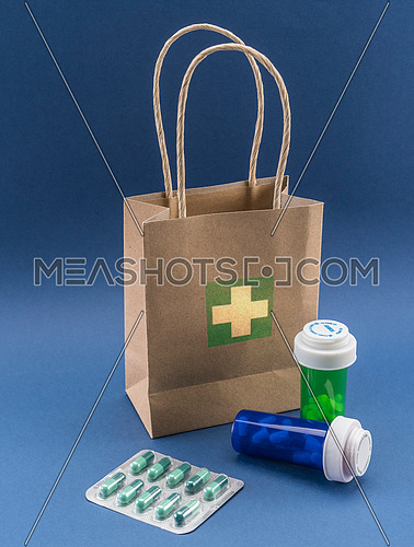 Several medicines with a cardboard bag, conceptual image