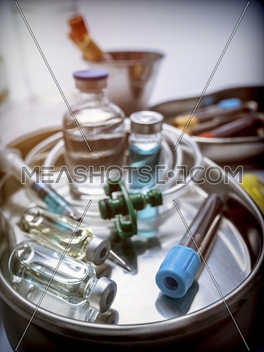 Several vials and blood sample in a metal tray, conceptual image