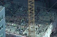 a construction site with workers and crane