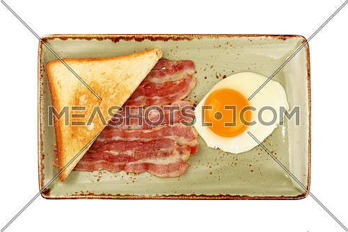 Close up English breakfast, sunny side egg, half of toasted bread and roasted bacon slices on blue plate isolated on white background, elevated top view, directly above