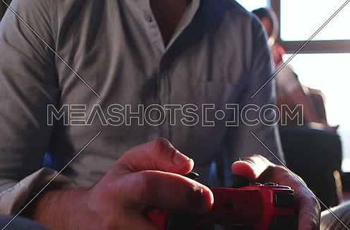Young man playing videogames with his controller