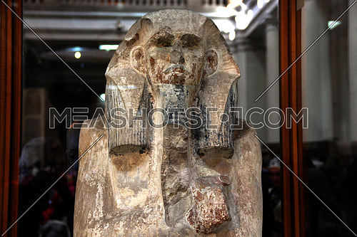 a photo from inside the Egyptian museum showing a pharaoh monumental statue during ancient Egypt civilization
