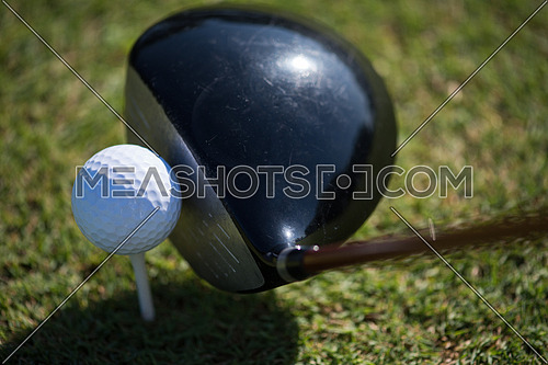 top view of golf club and ball in grass on course preparing for shot