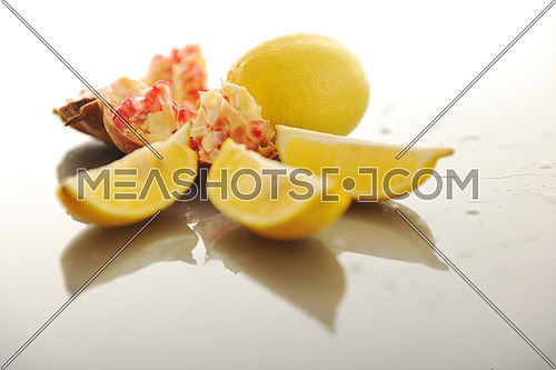 fresh and healthy fruit food lemon and Pomegranate isolated on white