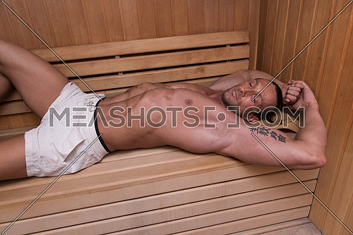 Good Looking And Attractive Mature Man With Muscular Body Relaxing In Sauna Hot