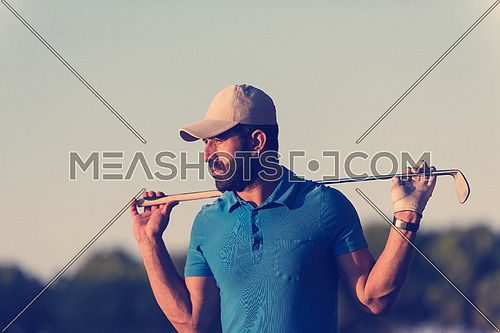 handsome middle eastern golfer portrait at golf course at beautiful sunset
