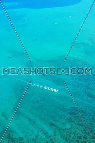 fast motor speed boat travel with splash and wake on blue tropical sea backround