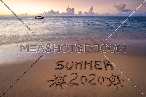Handwritten Summer 2020 on sandy beach at sunset,relax and summer concept,Dominican republic beach.