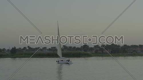 Fly over the River Nile showing a Sailboat at sunset.