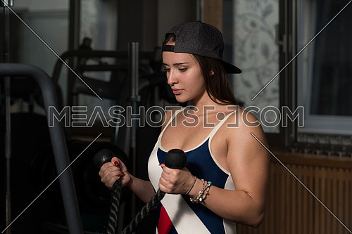 Young Woman Doing Heavy Weight Exercise For Biceps