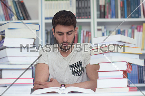 Student reading book in school library. Study lessons for exam. Hard worker and persistance concept.