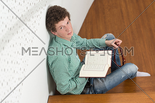 White Muslim Man Is Reading The Koran In The Mosque - Afro Lock Hair Curly