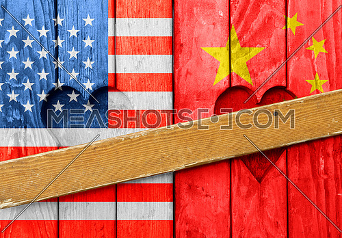 Close up closed wooden window shutters with heart shapes, American and Chinese flags painted as symbol of trade war