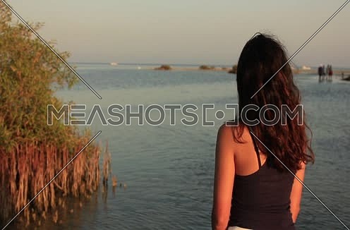 Follow shot for a girl walking into the sea at wadi lahmi at day - 5D
