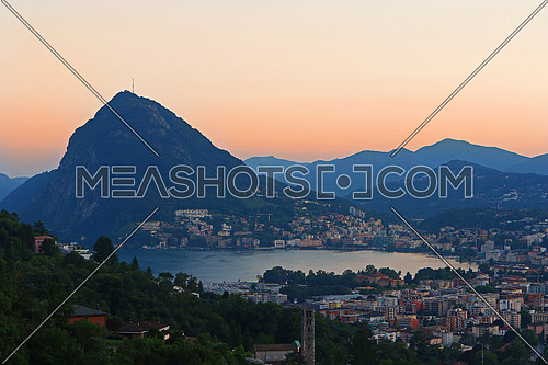 The bay of Lugano at dusk with Mount San Salvatore