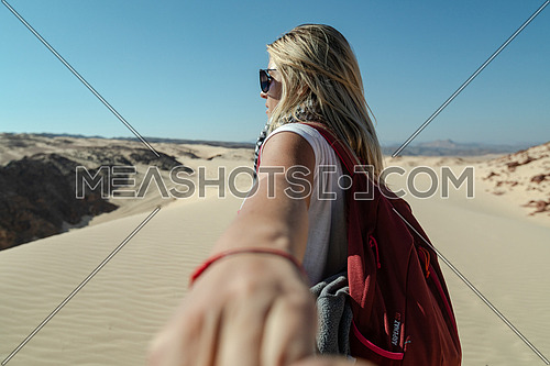 Follow me shot with blond female tourist