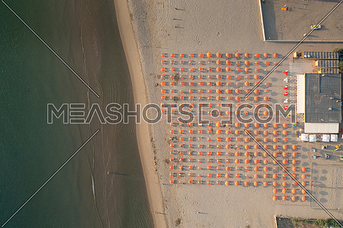 Birds view drone of the umbrellas and gazebos on Italian sandy beaches. Adriatic coast. Emilia Romagna region, Lido Adriano, Italy