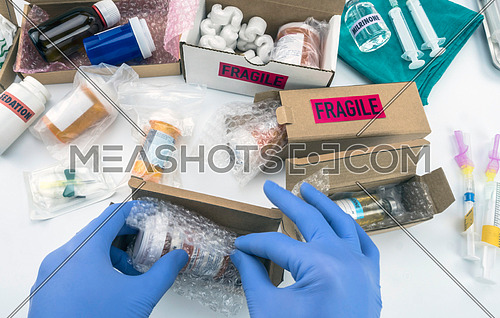 Nurse unpacking medication in boxes, conceptual image, horizontal composition