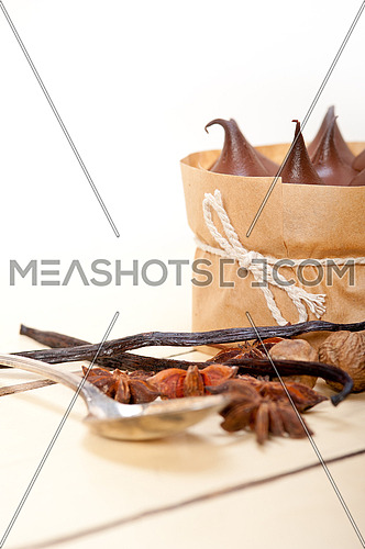 fresh baked chocolate vanilla and spices cream cake dessert over rustic wood table