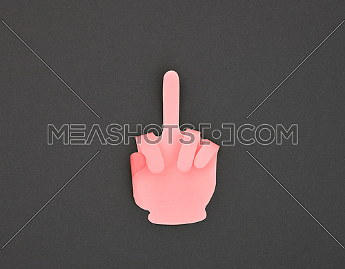 Paper made pink hand in rude offensive finger gesture sticker over grey background