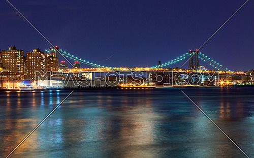 Williamsburg bridge by night, spanning the East River between Brooklyn and Manhattan Manhattan and Williamsburg bridges span across the East River between Manhattan and Brooklyn boroughs.