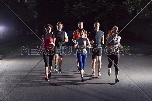 people group jogging at night, runners team on early morning  training
